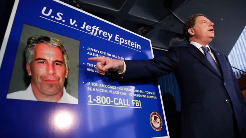 Geoffrey Berman displaying a poster of Jeffrey Epstein.  