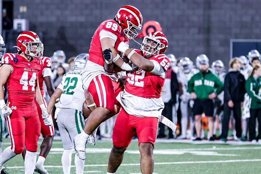 Mater Dei's Tomuhini Topui (52) celebrates with Semi Taulanga after beating De La Salle to complete 13-0 season.