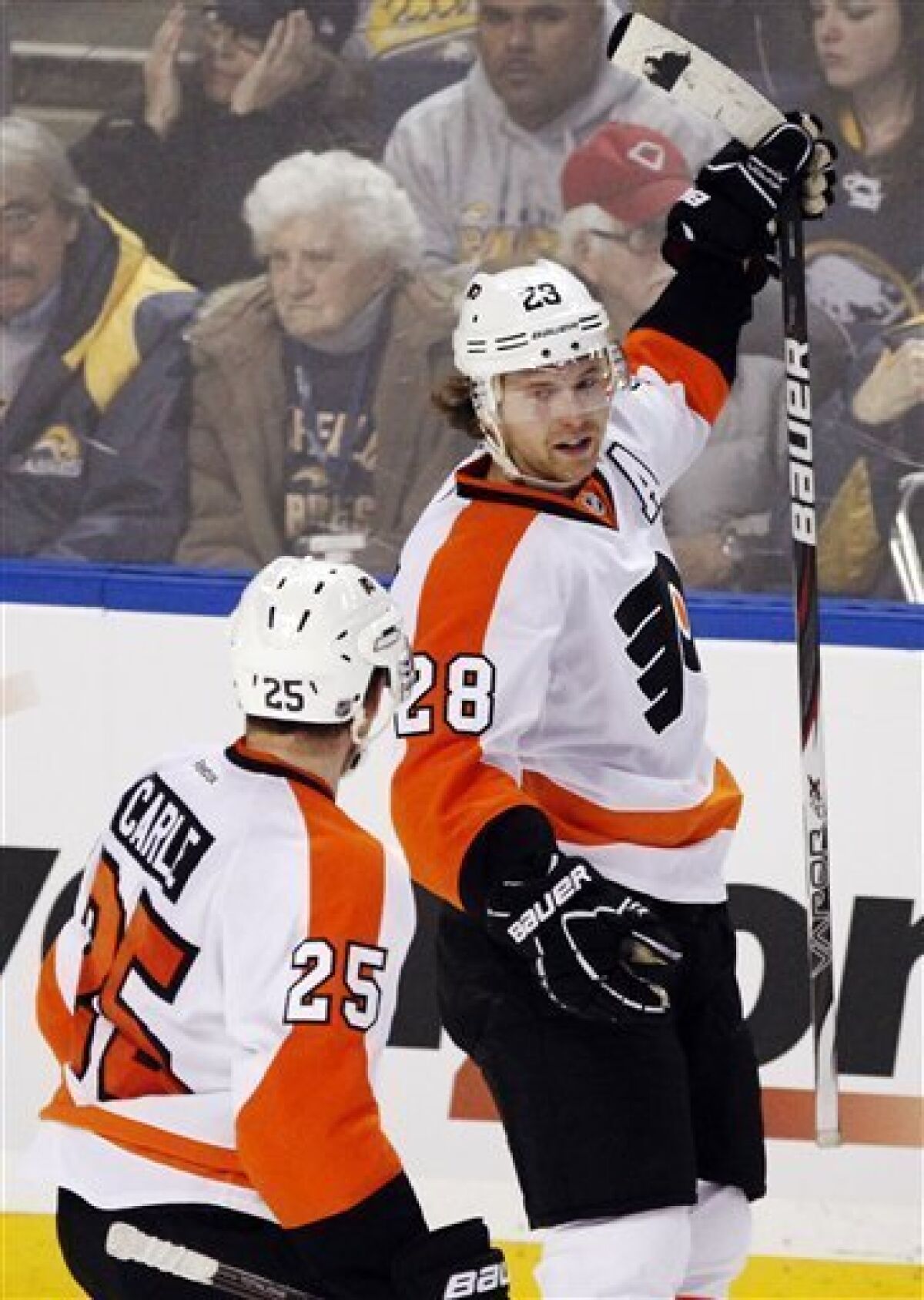 Philadelphia Flyers' Claude Giroux (28) celebrates his game-winning goal with teammate Erik Gustaffsson (25), of Sweden, during the overtime period of an NHL hockey game against the Buffalo Sabres in Buffalo, N.Y., Wednesday, Dec. 7, 2011. The Flyers won 5-4. (AP Photo/Derek Gee)