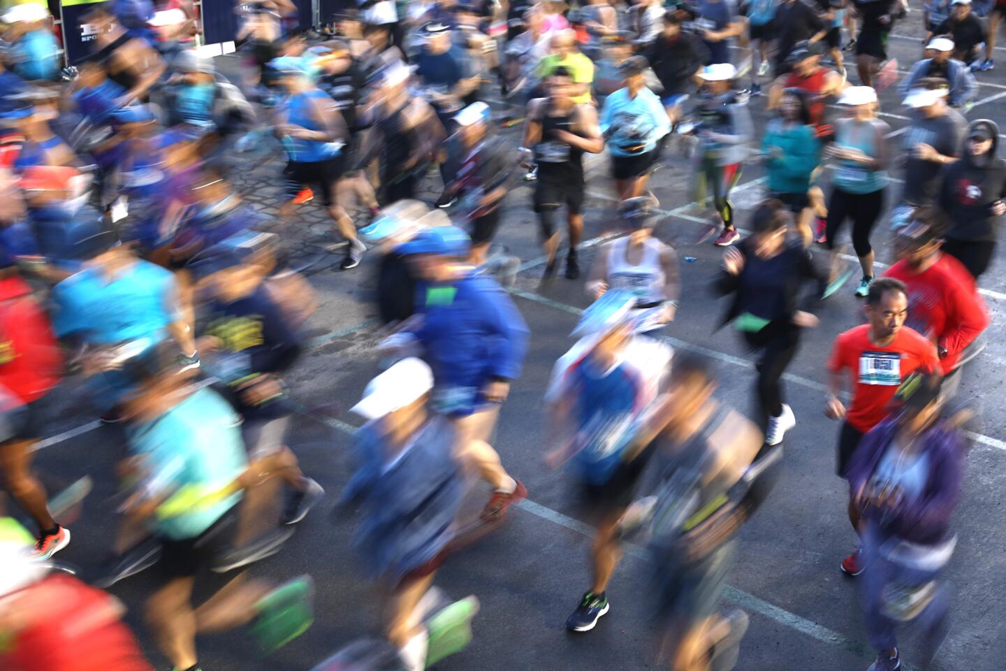 A time exposure shows runners in motion at the start of the 2020 L.A. Marathon at Dodger Stadium.