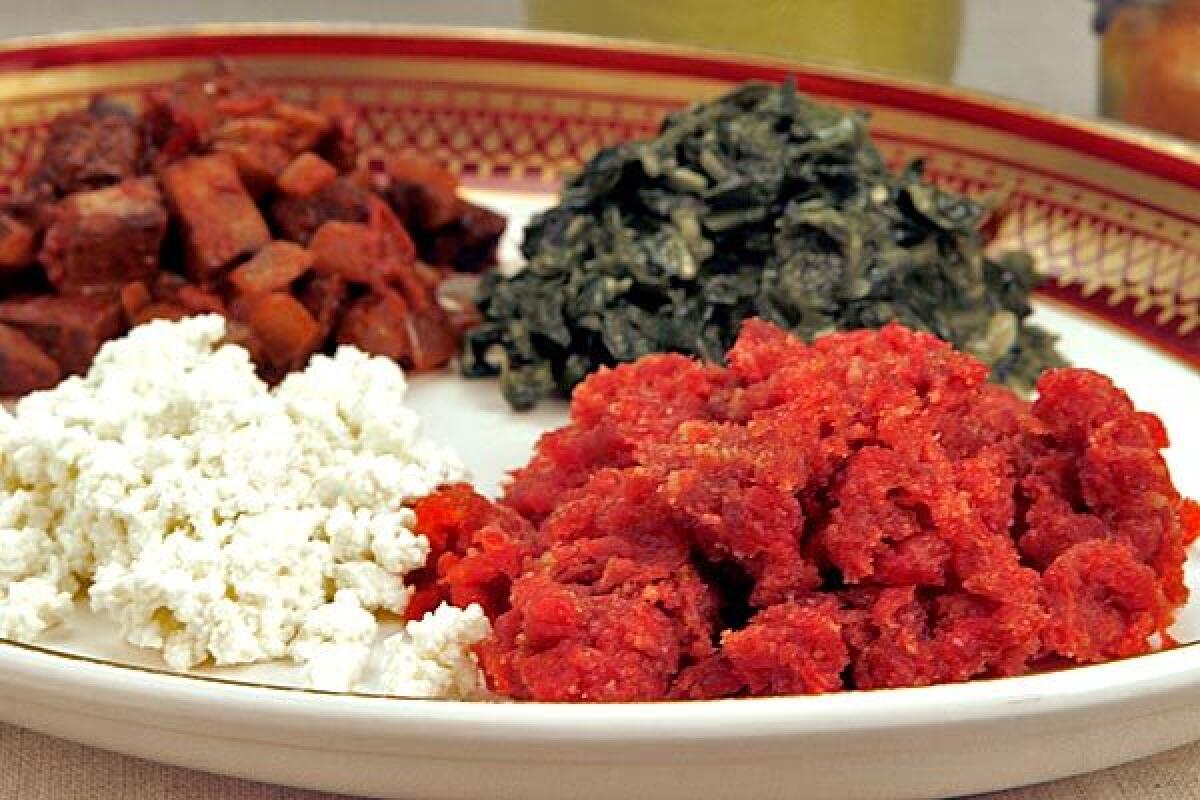 Spices, butter and ground beef make kitfo. It's served with cheese, mushrooms and collard greens.