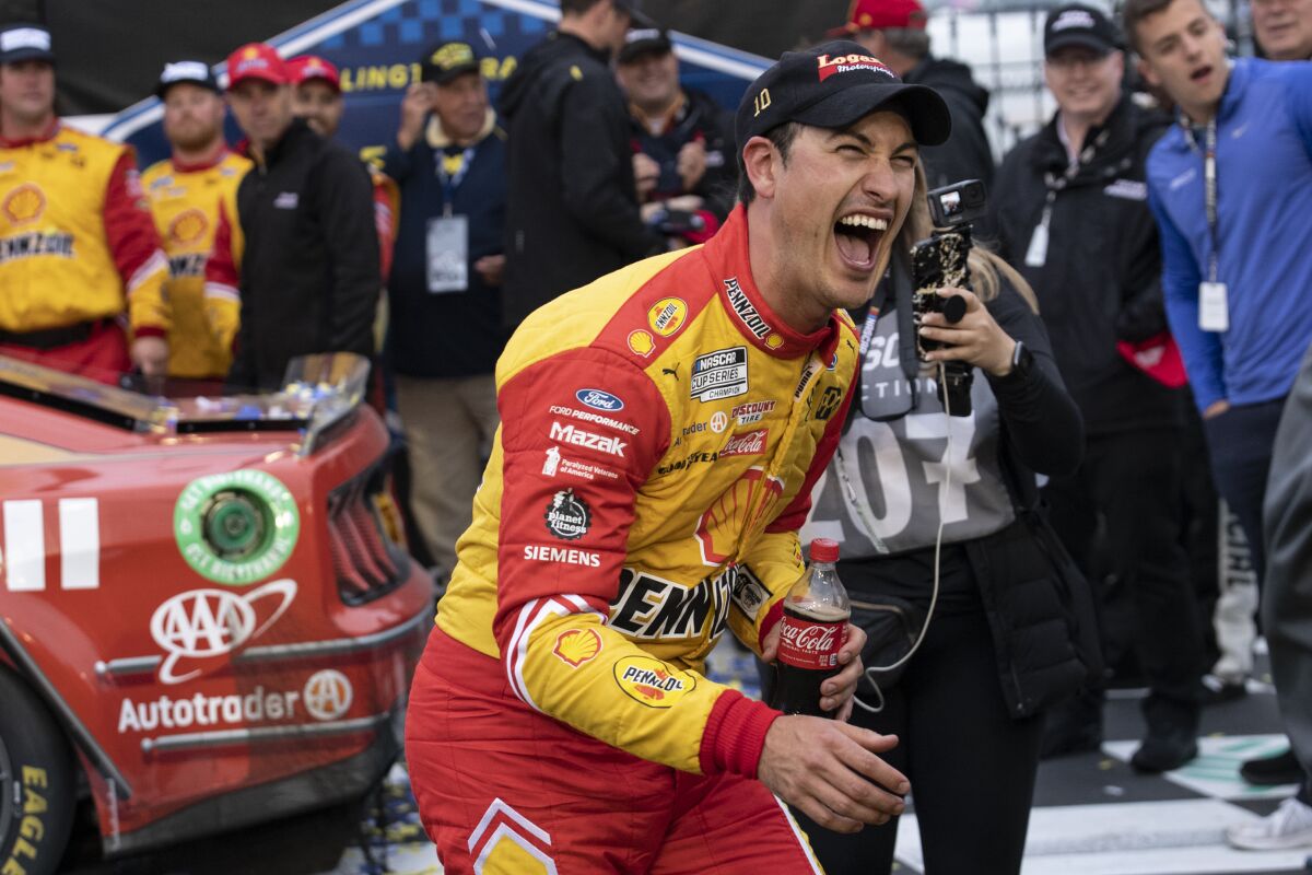 Joey Logano reacts in Victory Lane after winning a NASCAR Cup Series auto race at Darlington Raceway, Sunday, May 8, 2022, in Darlington, S.C. (AP Photo/Matt Kelley)