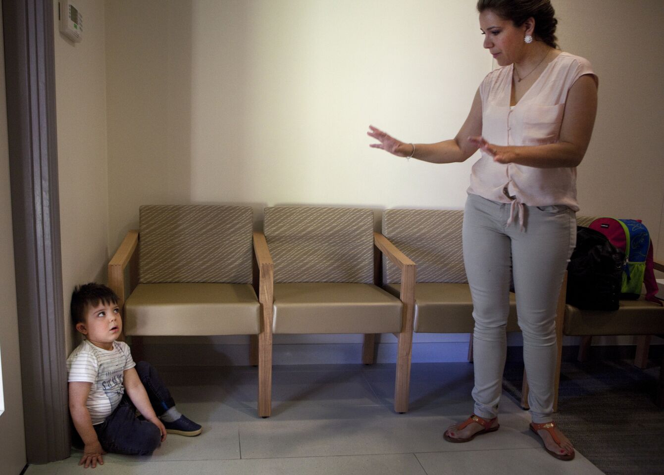 Auguste gets a timeout from his mother at USC Center for Childhood Communication while waiting for auditory tests.