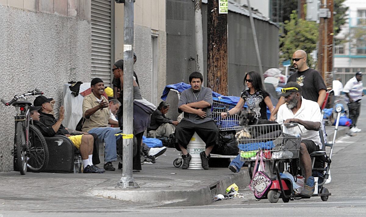 Homeless people with their belongings along streets in L.A.'s skid row. The city administrator's proposal would expand bathroom and storage options for the area's homeless.