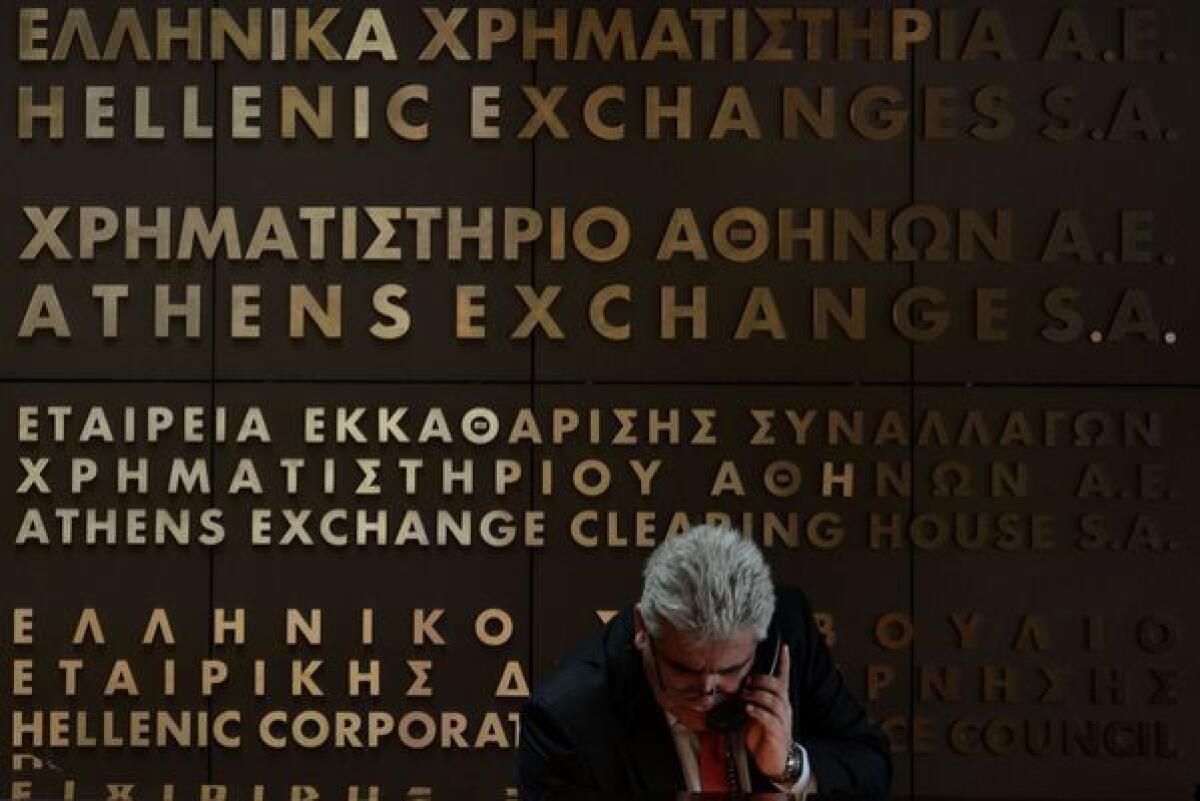 An employee of the Athens stock exchange talks on the phone.