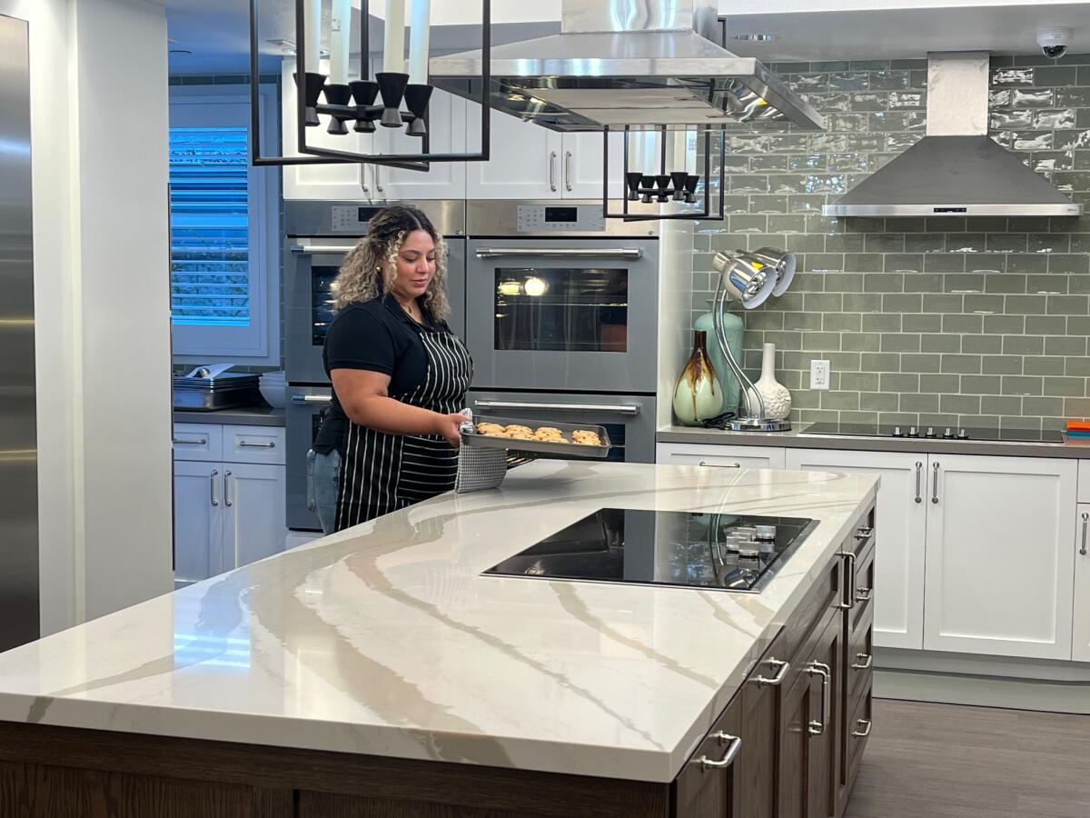 A volunteer pulls cookies from the oven inside Ronald McDonald House Orange County's new expanded kitchen.