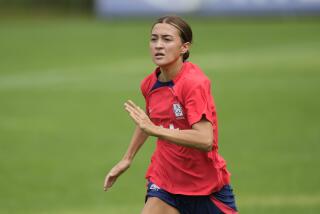 South Korea's women national soccer team player Casey Phair warms up during a training session.