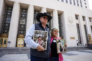 Avery Schott, left, and Lori Schott, right, hold photographs of their daughter
