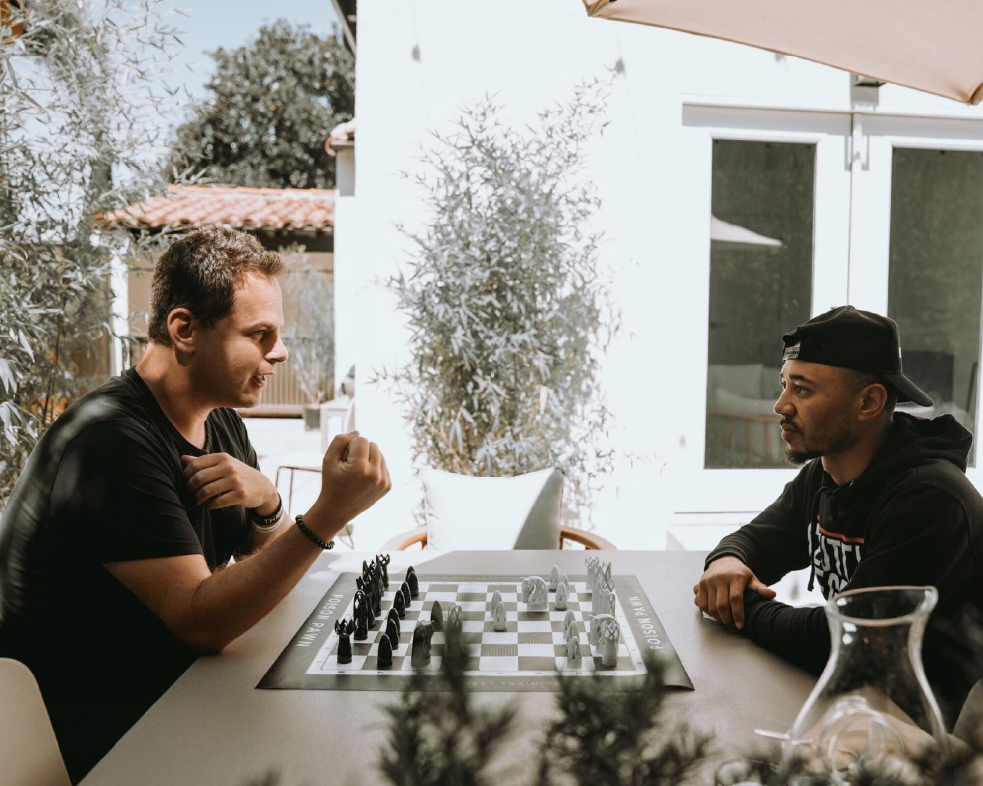 The Dodgers' Mookie Betts, right, plays chess with Seth Makowsky.