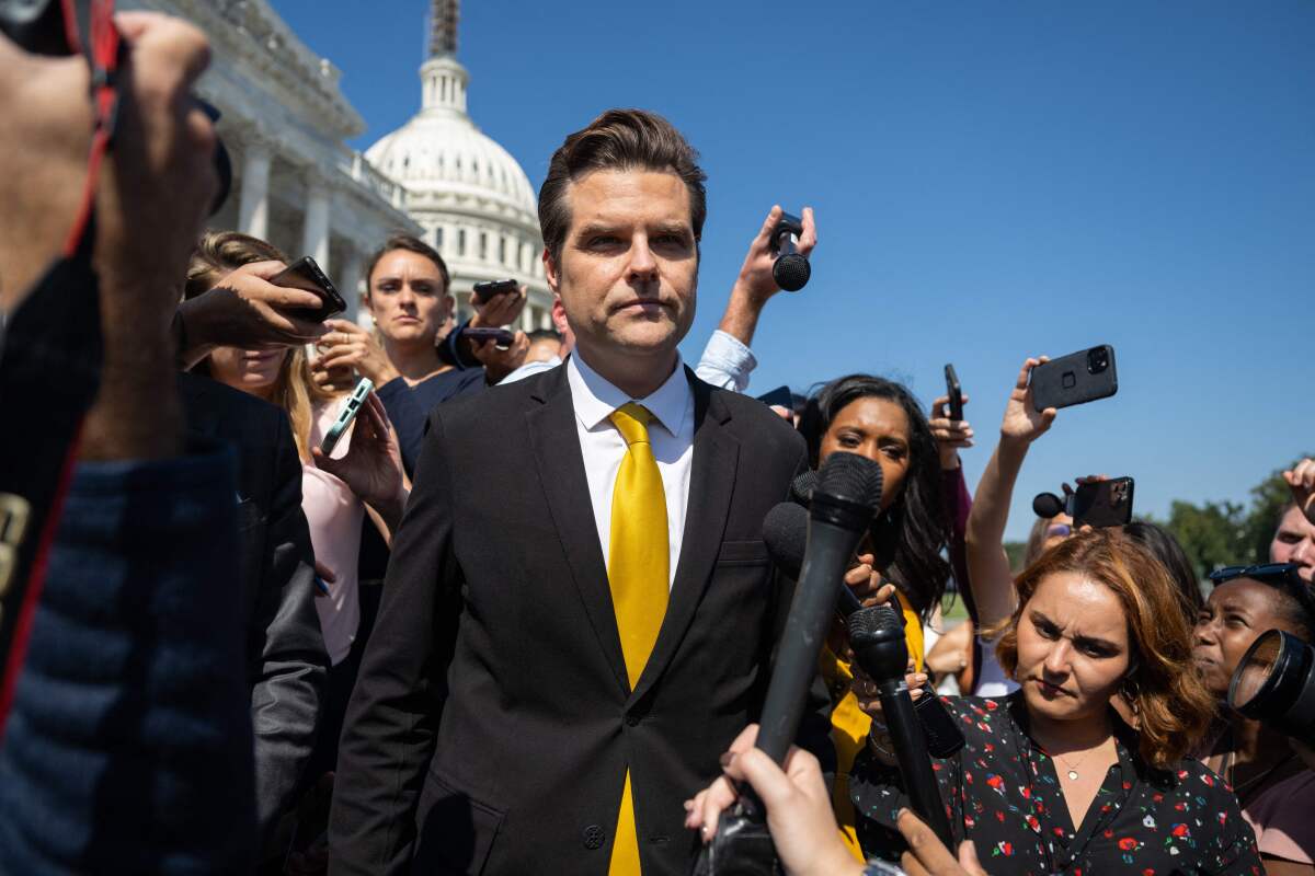 Matt Gaetz walks outside the Capitol with reporters.