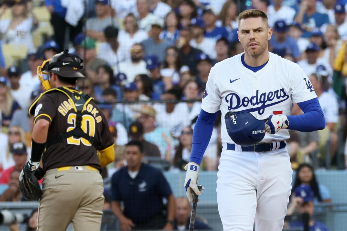 Dodgers first baseman Freddie Freeman walks back to the dugout after striking out in the first inning.