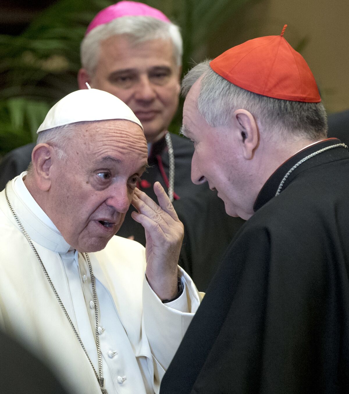 Pope Francis talks to Vatican Secretary of State, Cardinal Pietro Parolin.