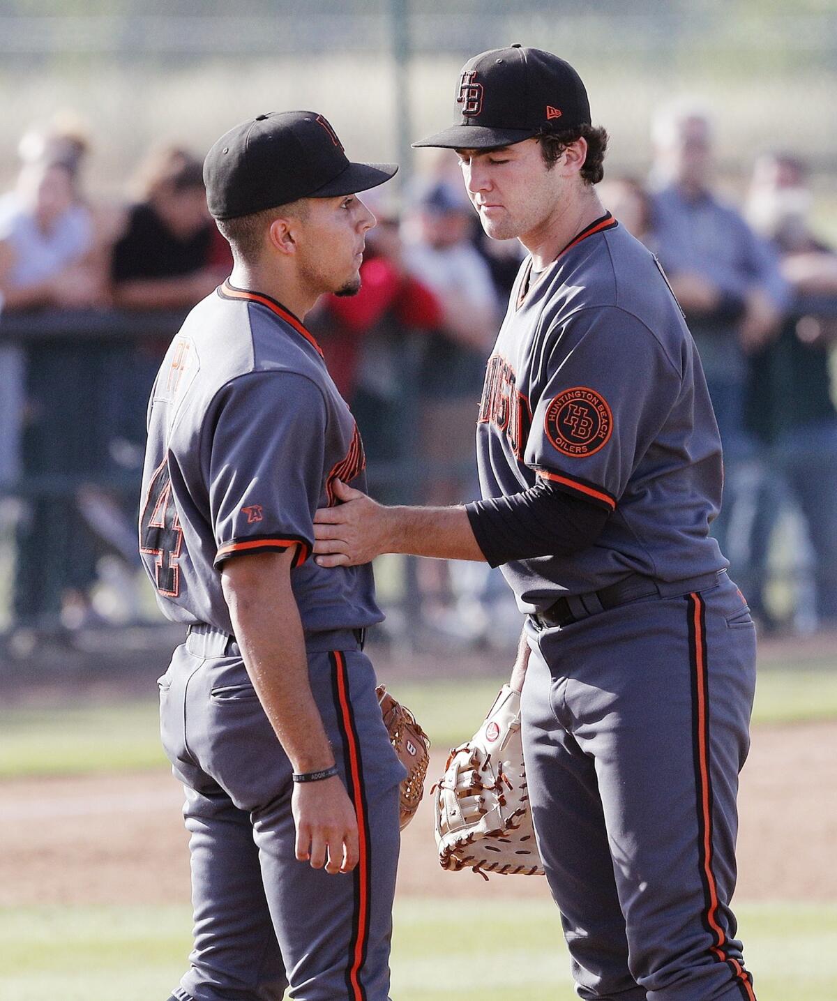 Huntington Beach High's Josh Hahn, right, consoles reliever Edward Pelc after Studio City Harvard-Westlake scored four runs in the sixth inning of a CIF Southern Section Division 1 semifinal playoff game on Tuesday.