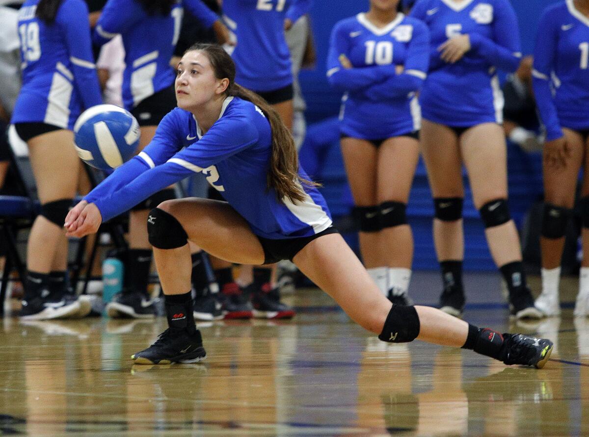 Burbank's Katie Treadway drops low to keep a Burroughs serve in play in a Pacific League girls' volleyball match at Burbank High School on Tuesday, September 24, 2019. Burroughs swept the match 3-0.