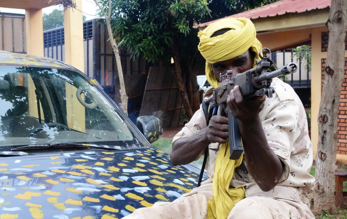 A Seleka fighter poses with his weapon in the Central African Republic capital, Bangui, in July.