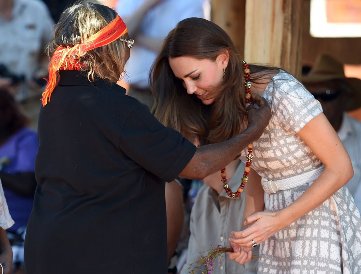Catherine receives a necklace from an Aboriginal elder during a visit to Uluru-Kata Tjuta Cultural Centre at Uluru in the Northern Territory.