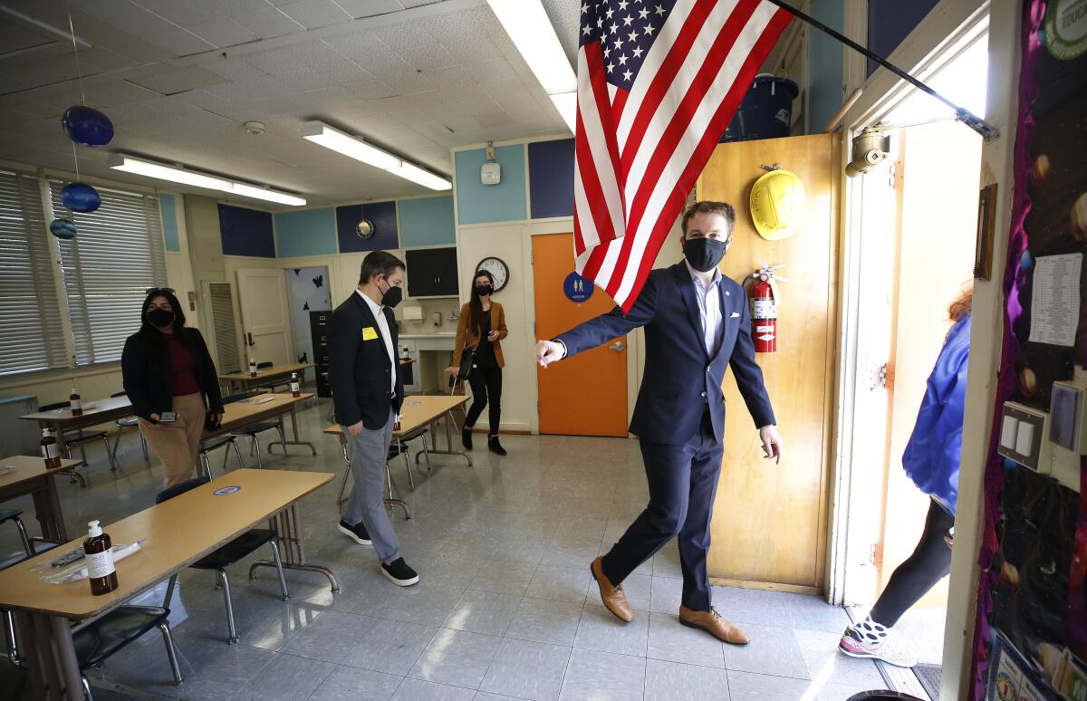 L.A. school board member Nick Melvoin walks out of a classroom.