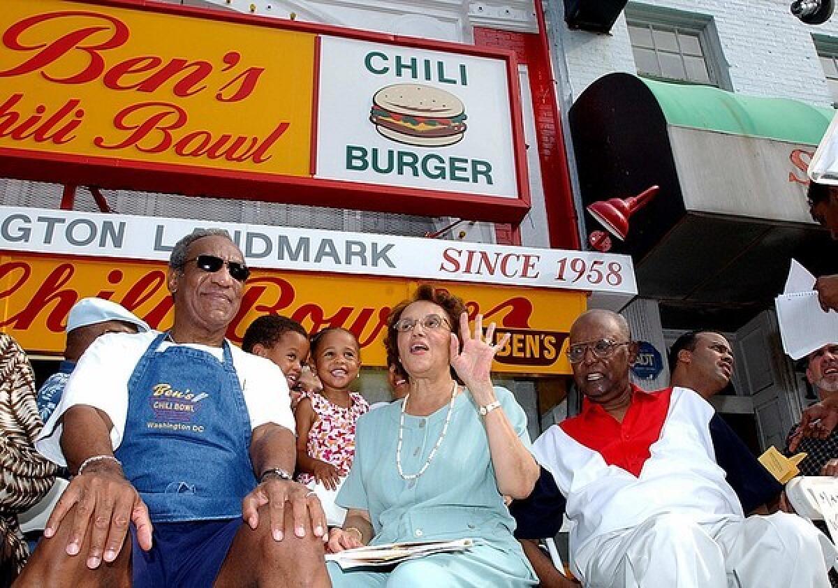 Ben Ali, right, and his wife, Virginia, are joined by comedian Bill Cosby during Ben's Chili Bowl's 45th anniversary celebration.