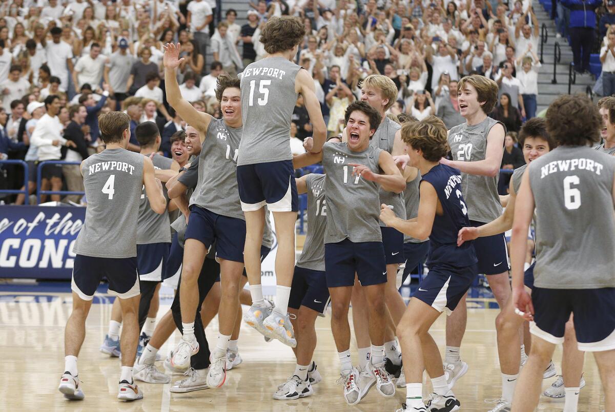Newport Harbor players rush the court after sweeping Corona del Mar in the CIF Division 1 final on Saturday.