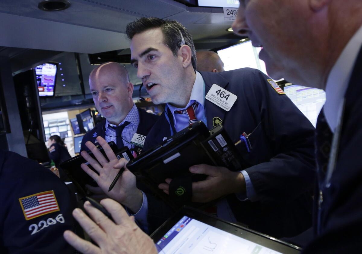 Traders work at the New York Stock Exchange on Friday.
