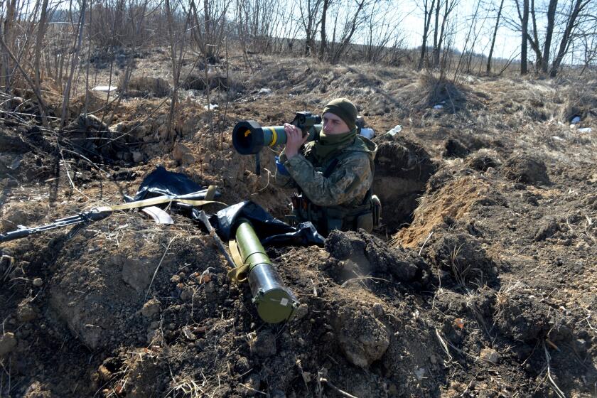 A serviceman of Ukrainian military forces holds a FGM-148 Javelin, an American-made portable anti-tank missile, at a checkpoint, where they hold a position near Kharkiv on March 23, 2022. (Photo by Sergey BOBOK / AFP) (Photo by SERGEY BOBOK/AFP via Getty Images)