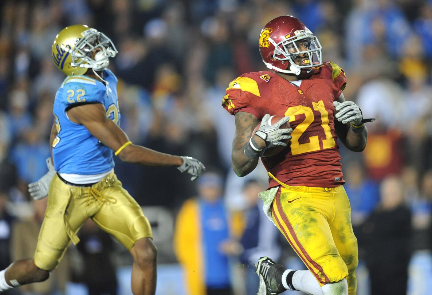 USC running back Allen Bradford beats UCLA's Sheldon Price to the end zone for a touchdown in the fourth quarter of a game at the Rose Bowl on Dec. 4, 2010.