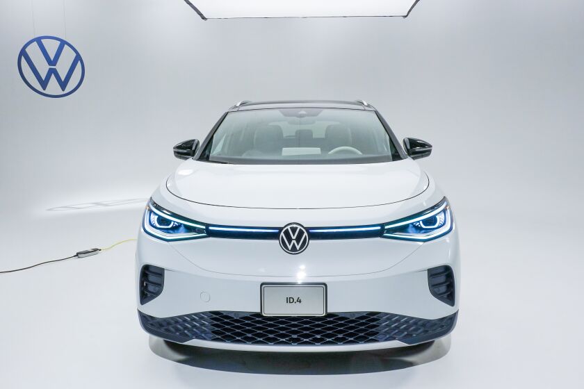 Volkswagen's ID.4 all-electric compact SUV shown from the front, photographed in a well lit studio