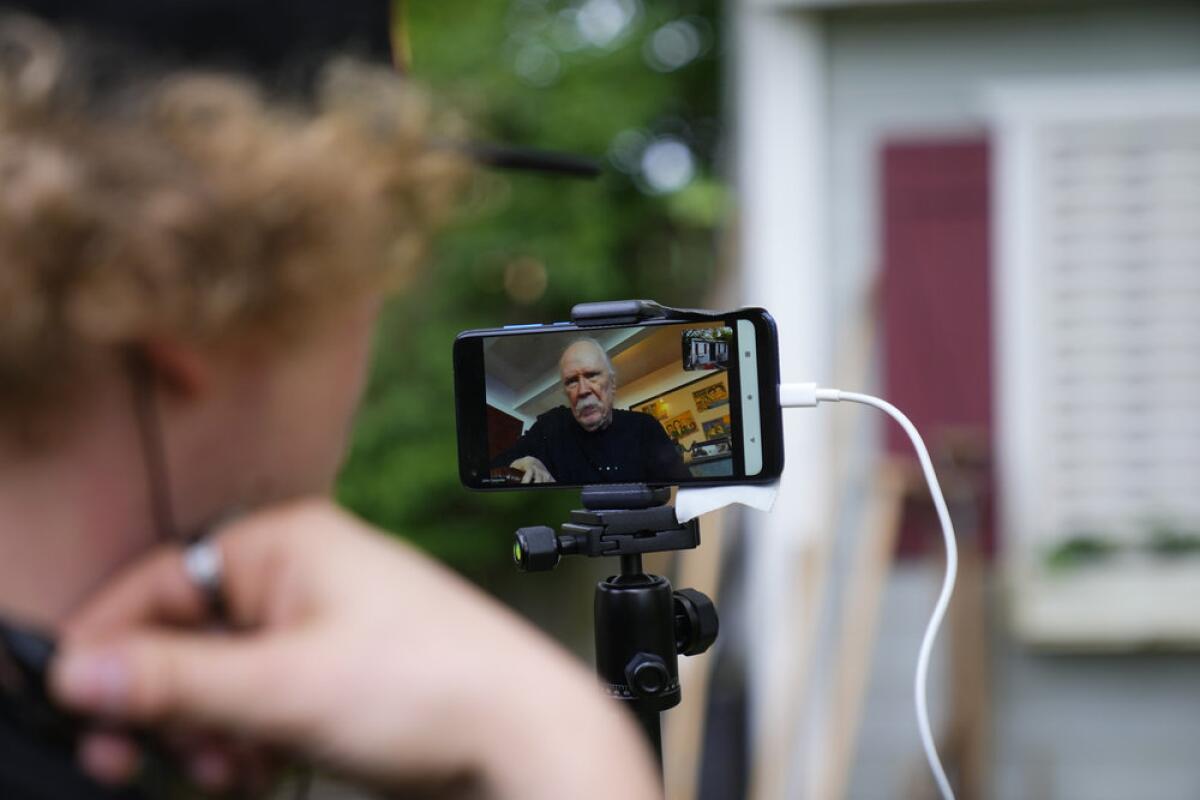 An image of John Carpenter on the screen of a phone.