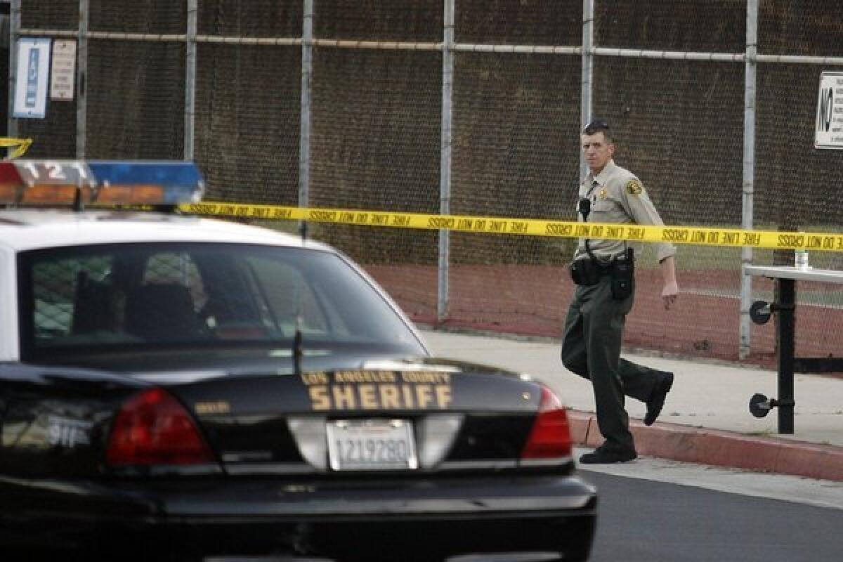 LA County's sheriff department secures the campus at La Canada High School on Friday, March 1, 2013. A student jumped from the junior high building, which was right across from the library at 3:55 p.m. He was pronounced dead later at the scene.