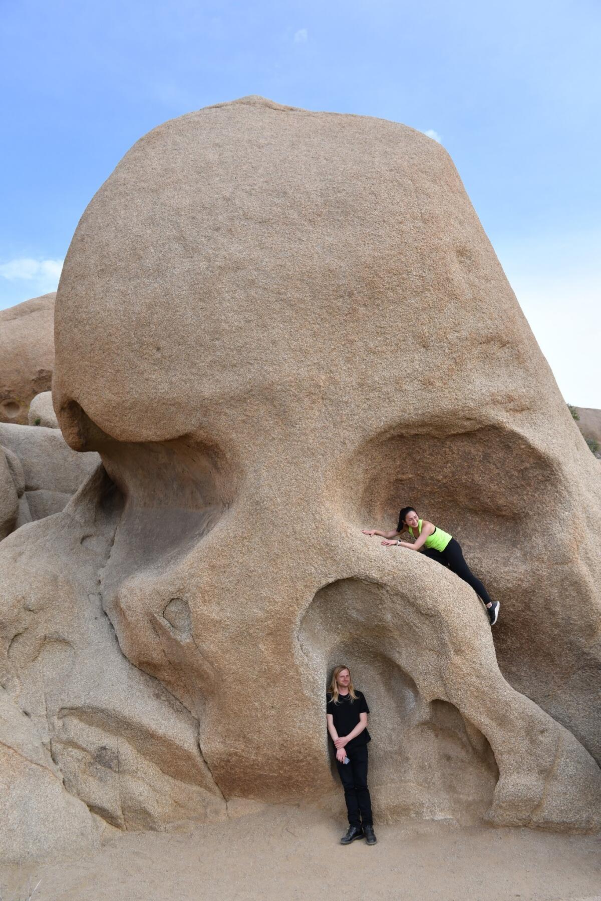 Visitors explore (and pose for photos) at Skull Rock in Joshua Tree National Park.