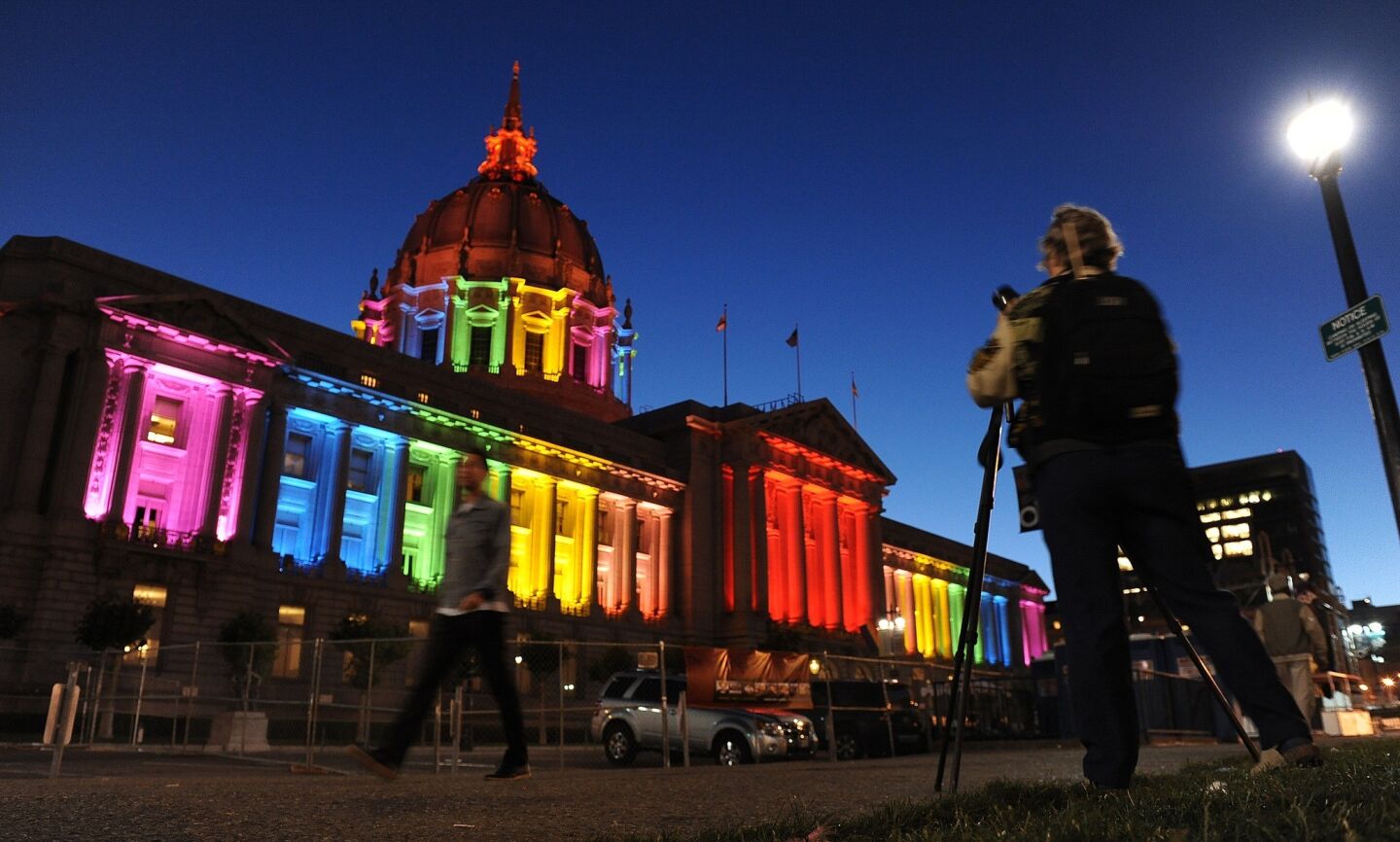 San Francisco City Hall is lit up in rainbow colors the night before the city's gay pride parade.