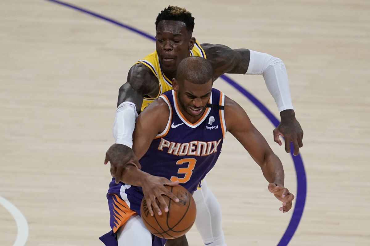 Los Angeles Lakers guard Dennis Schroder pressures Phoenix Suns guard Chris Paul  on the court