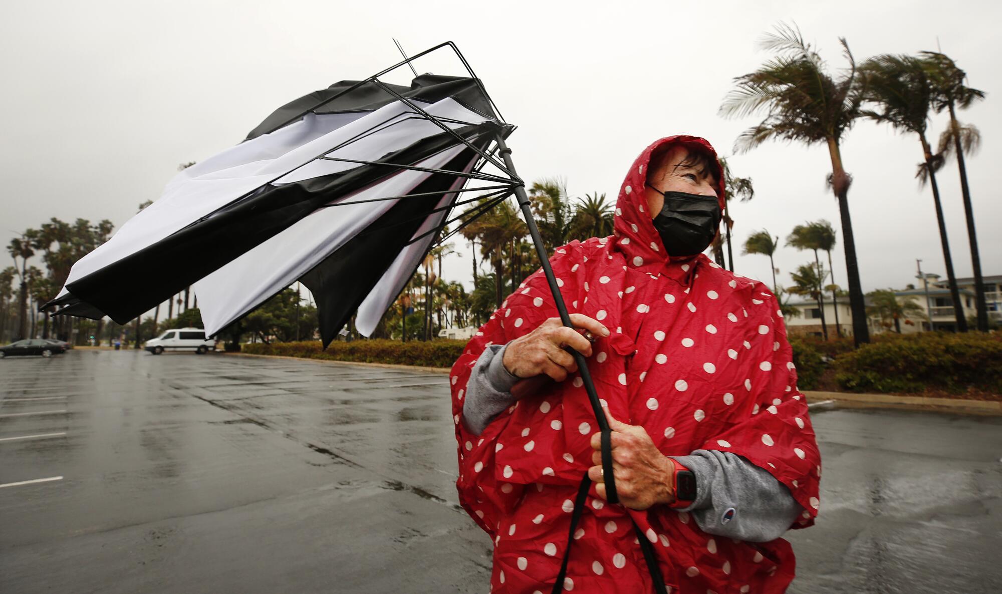 Carla LeJade's umbrella folds inside out due to the wind after a walk with a friend in Santa Barbara 