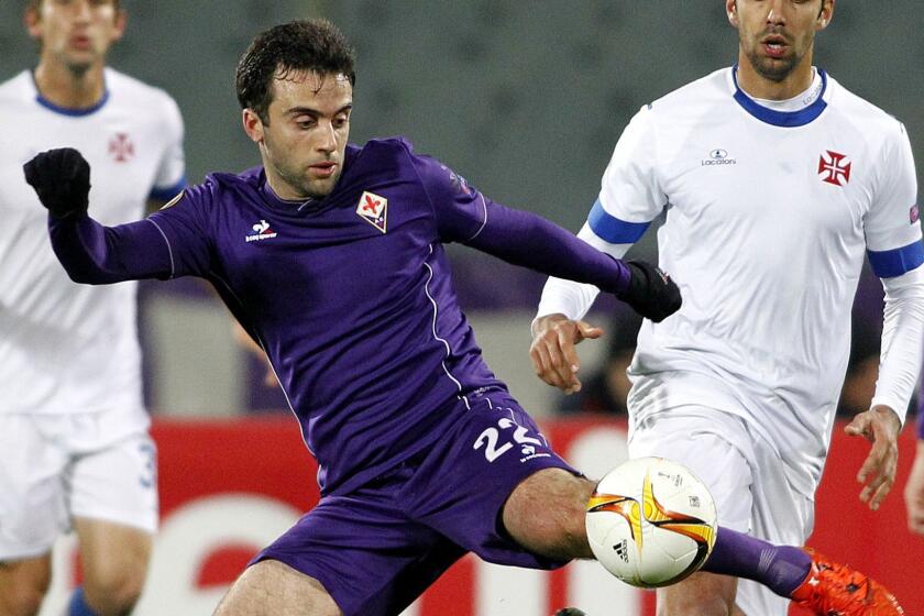 Fiorentina's Giuseppe Rossi, left, kicks the ball as Belenenses's Ricardo Dias watches him, during the Europa League match between Fiorentina and Belenenses, at the Artemio Franchi stadium in Florence, Italy, Thursday, Dec. 10, 2015. (AP Photo/Fabrizio Giovannozzi)