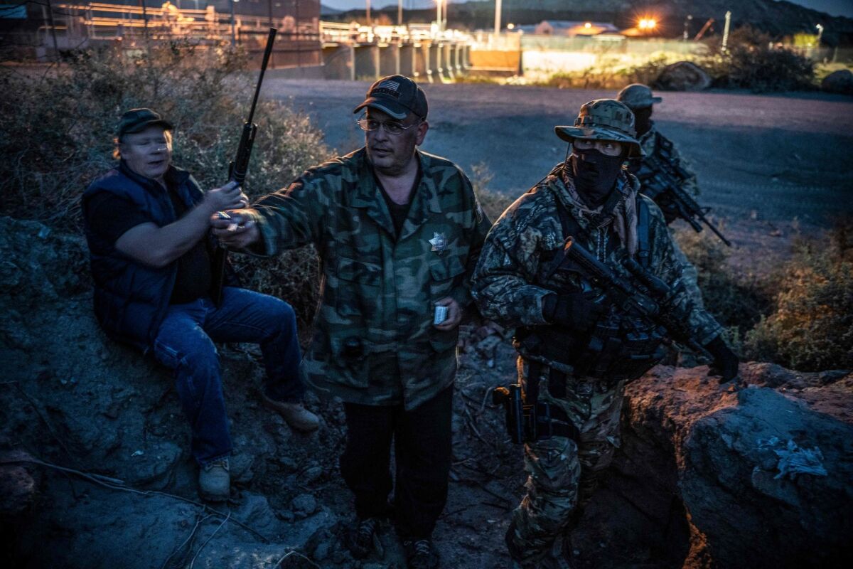 Militia members patrol the U.S.-Mexico border in Sunland Park, N.M., recently.