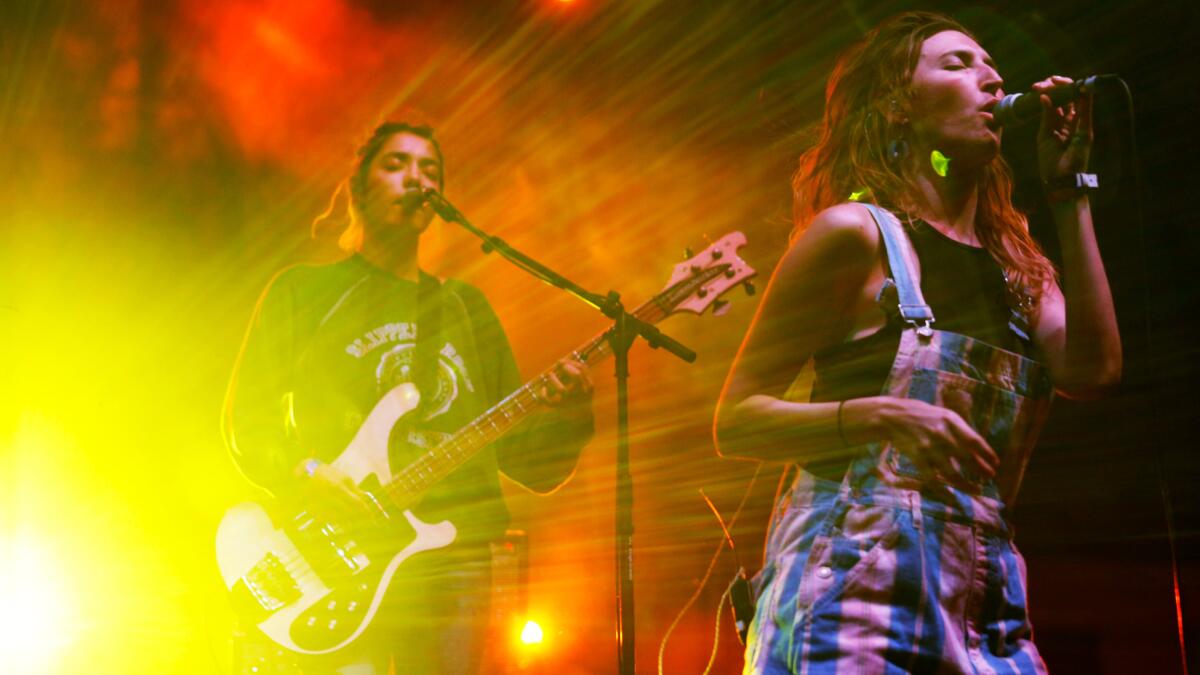 Jenny Lee Lindberg, left, and Emily Kokal of Warpaint perform on the second night of Long Beach's Music Tastes Good festival.