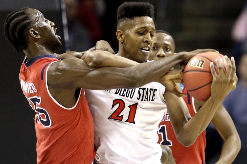St. John's Sir'Dominic Pointer (15) and San Diego State's Malik Pope (21) battle for a rebound in the first half of the Aztecs' 76-64 victory on Friday.