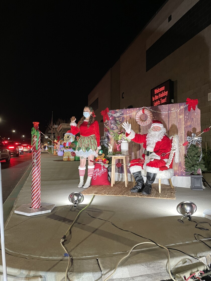 Santa and a friend welcome participants to the Holiday Lights Tour Dec. 18.