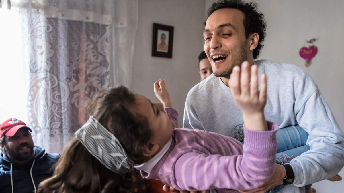 Egyptian photojournalist Mahmoud Abou Zeid, widely known as Shawkan, plays with his niece at his home in Cairo on March 4.