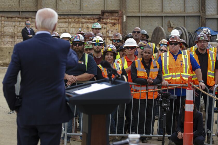 Los Angeles, CA - October 13: Construction crew listens to President Joe Biden address at the construction site for the future terminus of the Metro D (Purple) Line near the West Los Angeles VA Campus on Thursday, Oct. 13, 2022 in Los Angeles, CA. (Irfan Khan / Los Angeles Times)