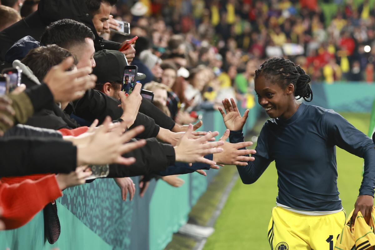 Colombia's Linda Caicedo celebrates with fans after her team defeated Jamaica and advanced at the World Cup.
