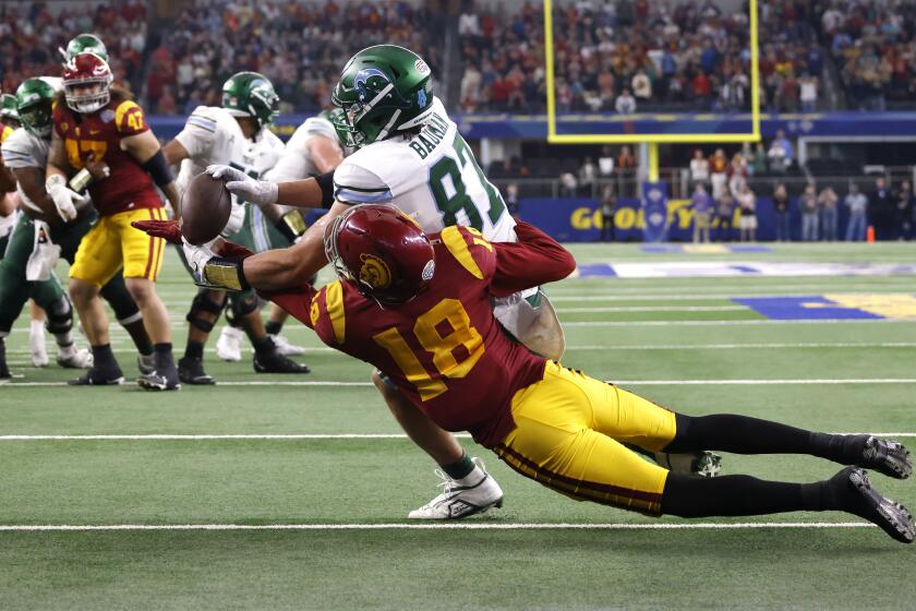 ARLINGTON, TX - JANUARY 2: Alex Bauman #87 of the Tulane Green Wave catches the winning touchdown pass as Eric Gentry #18 of the USC Trojans defends in the second half of the Goodyear Cotton Bowl Classic on January 2, 2023 at AT&T Stadium in Arlington, Texas. Tulane won 46-45. (Photo by Ron Jenkins/Getty Images)