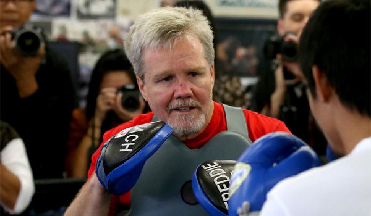 Trainer Freddie Roach works with boxer Manny Pacquiao at the Wild Card Boxing Gym in Hollywood on April 2.