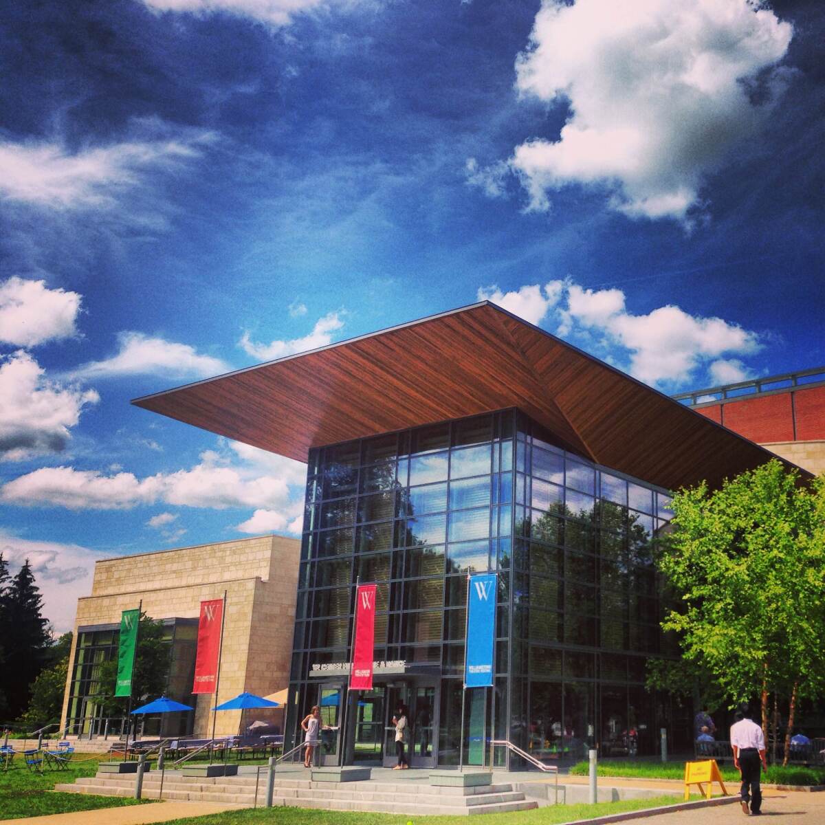 The outside of a college building with large glass windows