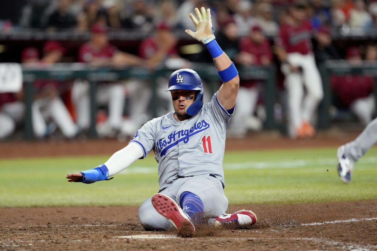 Dodgers baserunner Miguel Rojas scores on a hit by Shohei Ohtani during the eighth inning Monday.