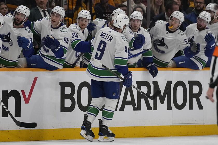 Vancouver Canucks center J.T. Miller (9) celebrates his goal with teammates during the first period in Game 3 of an NHL hockey Stanley Cup first-round playoff series against the Nashville Predators, Friday, April 26, 2024, in Nashville, Tenn. (AP Photo/George Walker IV)