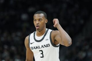 Oakland forward Micah Parrish plays during the first half of an NCAA college basketball game, Tuesday, Dec. 21, 2021, in Detroit. (AP Photo/Carlos Osorio)