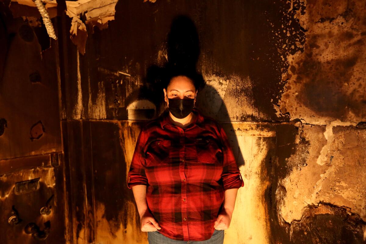 Stephanie Ramirez standing inside her fire damaged bakery, Spigas, in Orange.