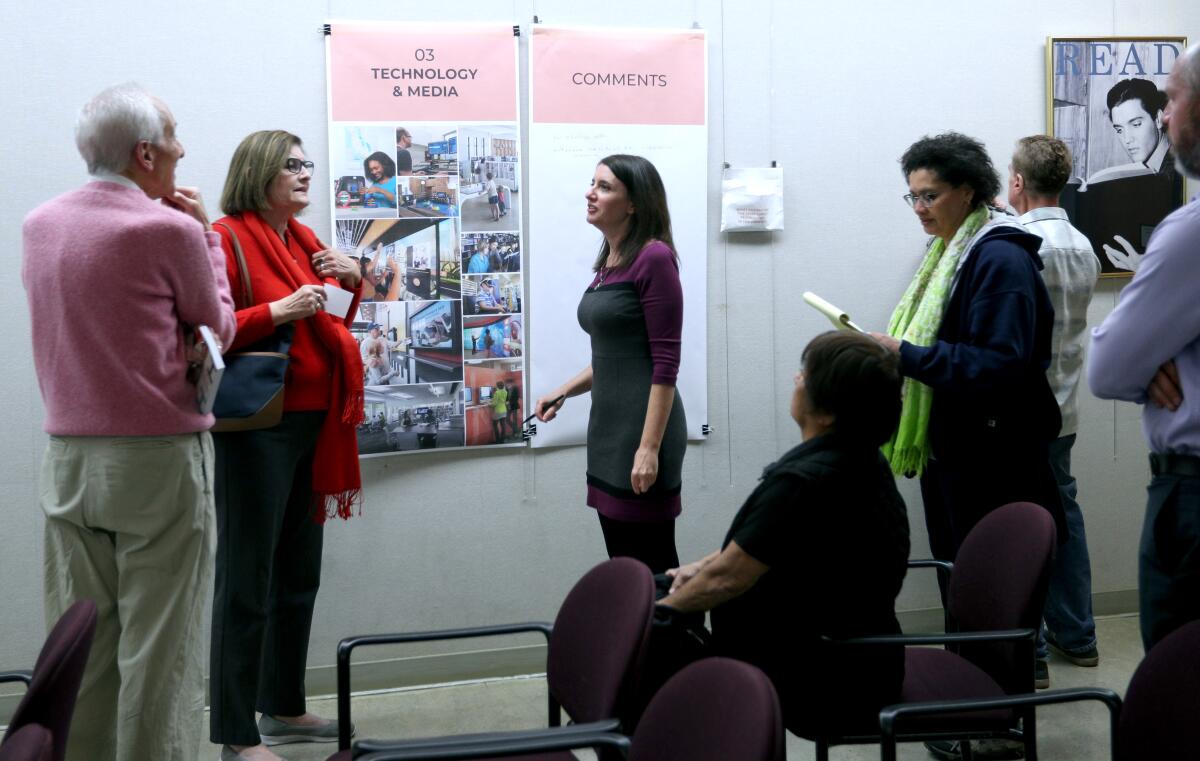 Burbank Public Library director Elizabeth Goldman, center, talks with locals about ideas for a proposed new library during a community meeting at the Central Library in Burbank on Thursday, Feb. 6.