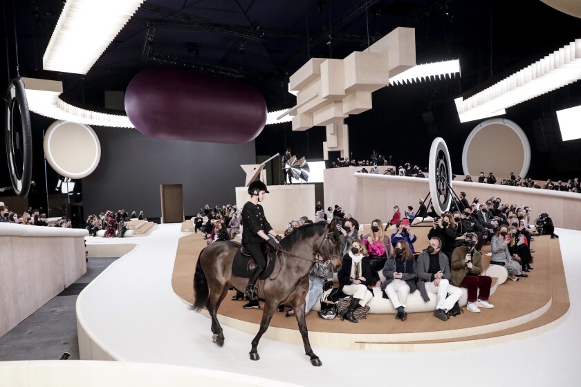 Charlotte Casiraghi rides a horse as she wears a creation for the Chanel Spring-Summer 2022 Haute Couture fashion collection collection, in Paris, Tuesday, Jan. 25, 2022. (AP Photo/Lewis Joly)